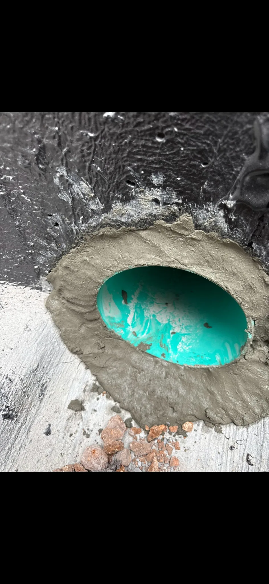 Concrete-sealed pipe connection detail